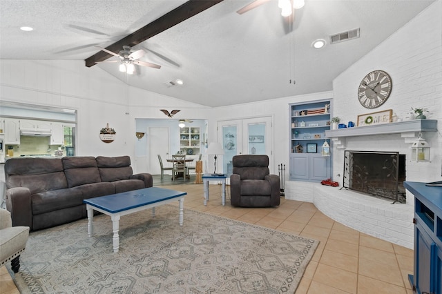 805 Sandpiper Dr, Denton, TX 76205 - living room featuring a ceiling fan, light tile patterned floors, a fireplace, a textured ceiling, and built in features