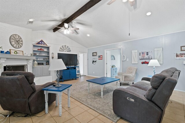805 Sandpiper Dr, Denton, TX 76205 - living room with a ceiling fan, light tile patterned flooring, a fireplace, and a textured ceiling