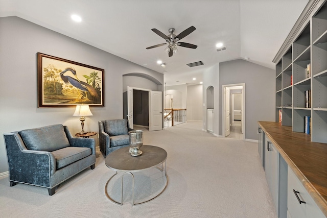 14322 Summerwoods Ln, Frisco, TX 75035 - living room featuring lofted ceiling, light carpet, a ceiling fan, baseboards, and arched walkways