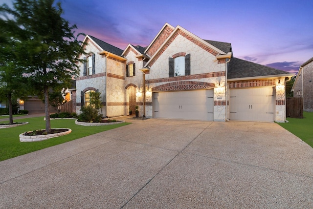 14322 Summerwoods Ln, Frisco, TX 75035 - french country style house featuring stone siding, concrete driveway, and a shingled roof