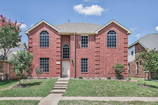 207 Trailwood Dr, Allen, TX 75002 - view of front of property with a front yard, brick siding, and roof with shingles