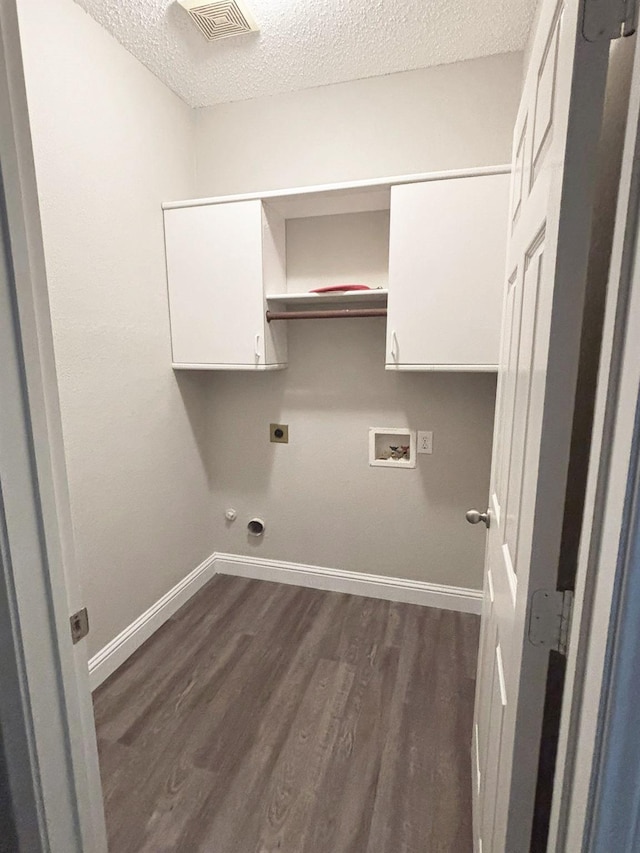 207 Trailwood Dr, Allen, TX 75002 - clothes washing area featuring a textured ceiling, cabinet space, hookup for an electric dryer, baseboards, and dark wood finished floors