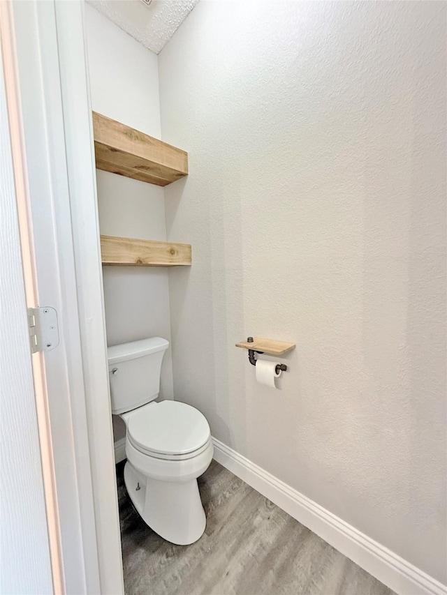 207 Trailwood Dr, Allen, TX 75002 - bathroom featuring wood finished floors, baseboards, and toilet