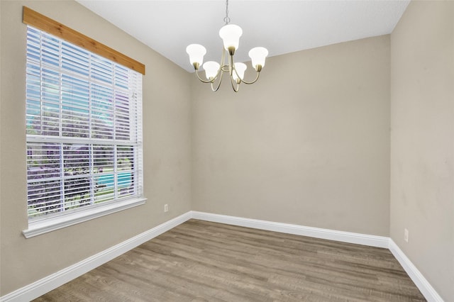 207 Trailwood Dr, Allen, TX 75002 - unfurnished room with a chandelier, wood finished floors, and baseboards