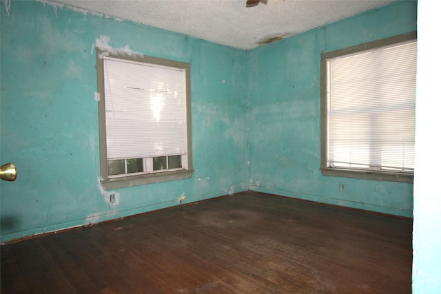 6645 Onyx Dr N, North Richland Hills, TX 76180 - empty room with wood-type flooring, a textured ceiling, and baseboards