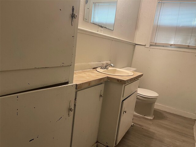 6645 Onyx Dr N, North Richland Hills, TX 76180 - bathroom featuring wood finished floors, vanity, toilet, and baseboards