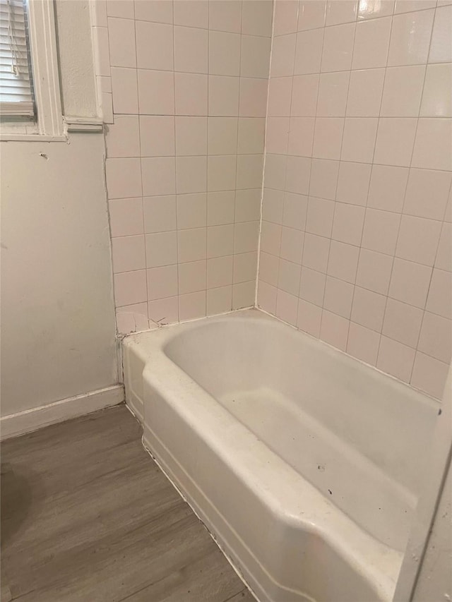 6645 Onyx Dr N, North Richland Hills, TX 76180 - bathroom featuring wood finished floors, a bathtub, and baseboards