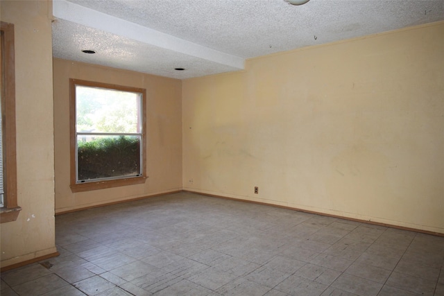 6645 Onyx Dr N, North Richland Hills, TX 76180 - spare room featuring a textured ceiling and baseboards