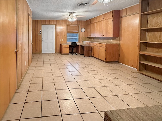 10550 Fm 215, Valley Mills, TX 76689 - kitchen with ceiling fan, light countertops, a textured ceiling, wooden walls, and light tile patterned flooring