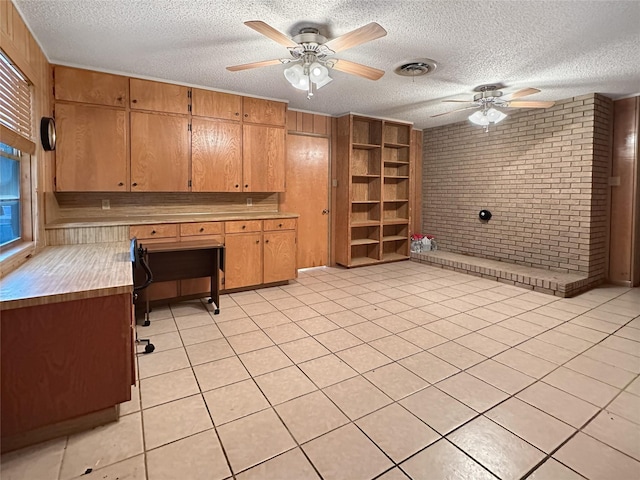 10550 Fm 215, Valley Mills, TX 76689 - kitchen with ceiling fan, brick wall, a textured ceiling, light countertops, and brown cabinets