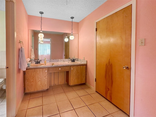 10550 Fm 215, Valley Mills, TX 76689 - full bath featuring toilet, double vanity, tile patterned floors, and a textured ceiling