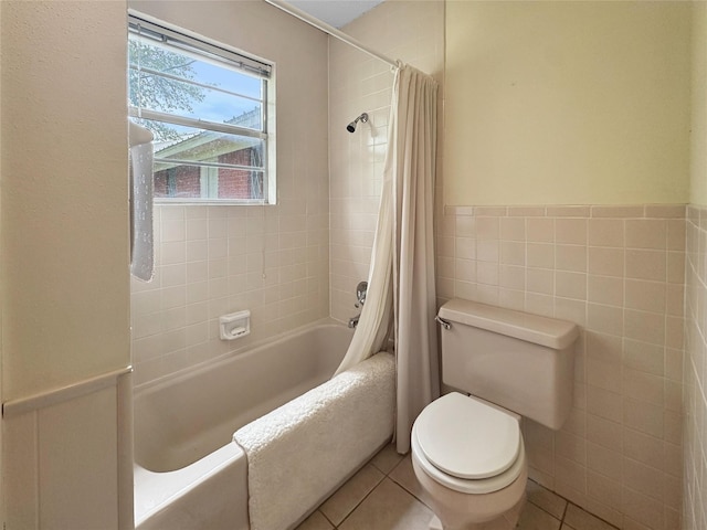 10550 Fm 215, Valley Mills, TX 76689 - full bathroom featuring toilet, tile patterned floors, shower / bath combination with curtain, tile walls, and a wainscoted wall