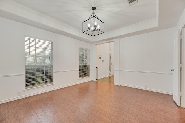 2904 Champlin Ct, Richardson, TX 75082 - unfurnished room with a chandelier, wood finished floors, a raised ceiling, ornamental molding, and baseboards