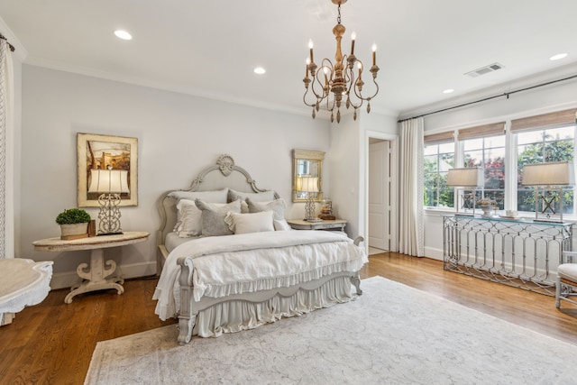 bedroom featuring ornamental molding, a chandelier, recessed lighting, wood finished floors, and baseboards