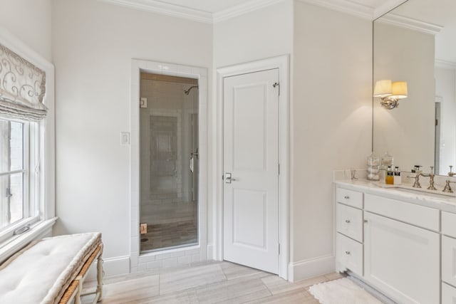 bathroom featuring a stall shower, baseboards, crown molding, tile patterned floors, and vanity