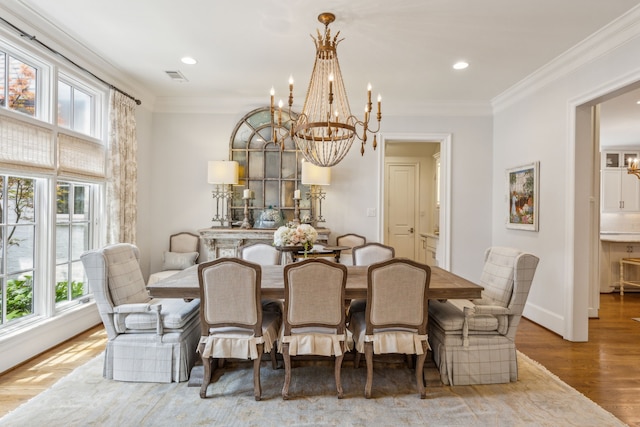 dining space featuring a chandelier, wood finished floors, crown molding, recessed lighting, and baseboards