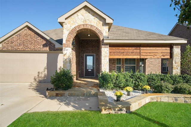 609 Racine Dr, Oak Point, TX 75068 - entrance to property featuring brick siding, a garage, stone siding, and driveway
