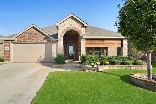 609 Racine Dr, Oak Point, TX 75068 - view of front facade with brick siding, a front lawn, an attached garage, stone siding, and driveway