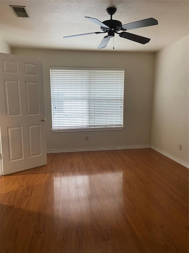 1102 N Main St, Leonard, TX 75452 - empty room featuring baseboards, a ceiling fan, and wood finished floors