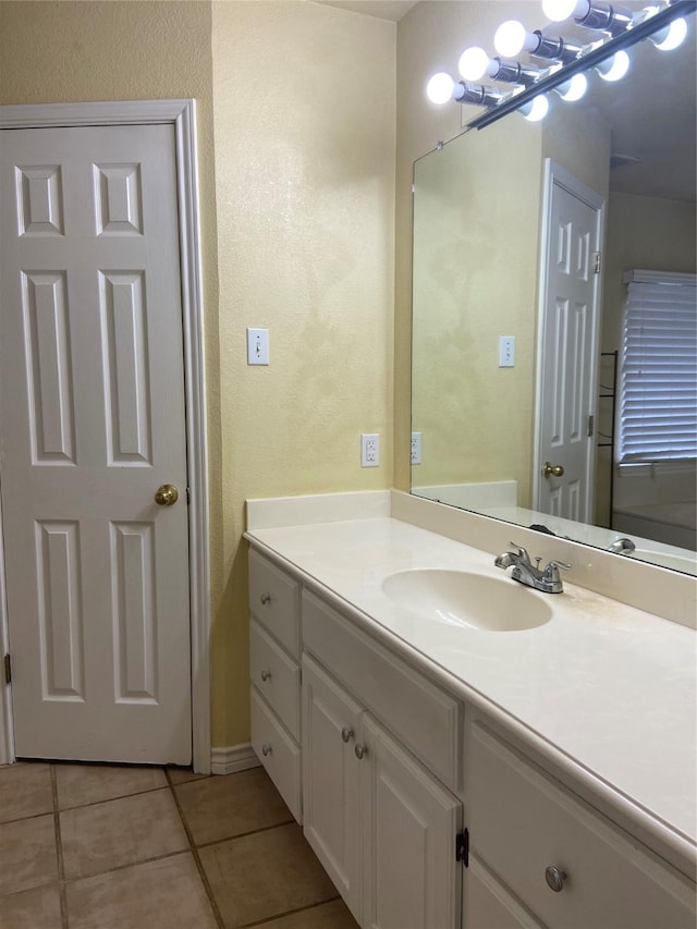 1102 N Main St, Leonard, TX 75452 - bathroom featuring tile patterned flooring, a textured wall, and vanity