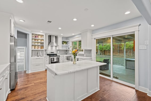 2306 Monte Cristo Dr, Sherman, TX 75092 - kitchen with wall chimney range hood, open shelves, appliances with stainless steel finishes, white cabinets, and decorative backsplash