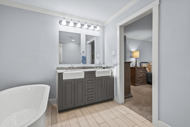 2306 Monte Cristo Dr, Sherman, TX 75092 - full bathroom with ensuite bathroom, crown molding, double vanity, a soaking tub, and wood tiled floors