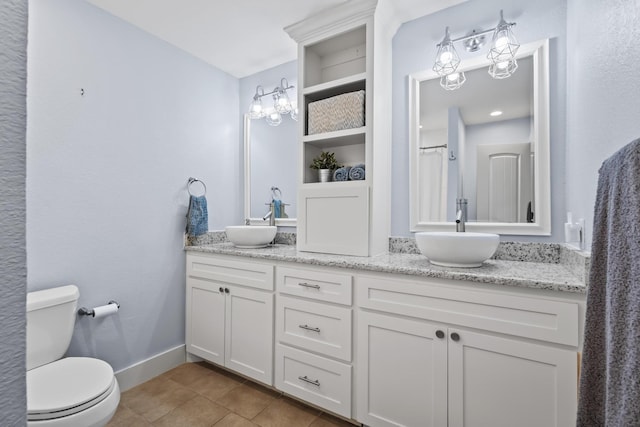 2306 Monte Cristo Dr, Sherman, TX 75092 - full bathroom with toilet, tile patterned floors, baseboards, and double vanity