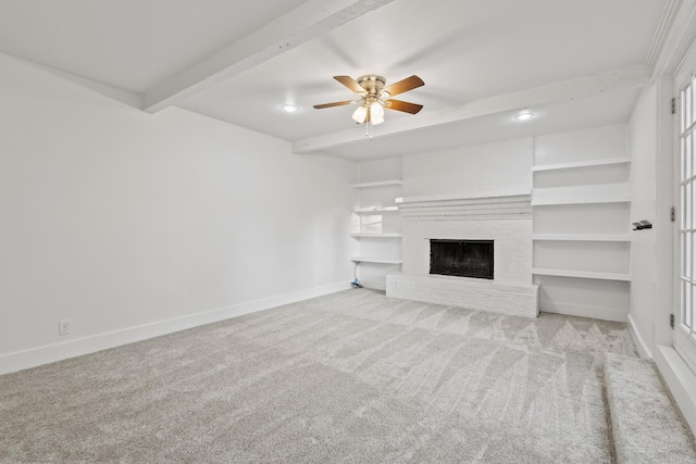 2306 Monte Cristo Dr, Sherman, TX 75092 - unfurnished living room with baseboards, ceiling fan, carpet floors, beamed ceiling, and a fireplace