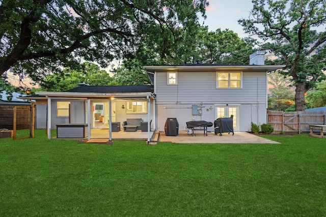 2306 Monte Cristo Dr, Sherman, TX 75092 - back of house at dusk with a patio and a chimney