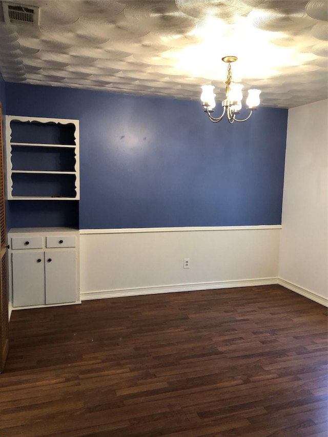 608 Spinner Rd, Desoto, TX 75115 - unfurnished room featuring dark wood-type flooring, a chandelier, and baseboards