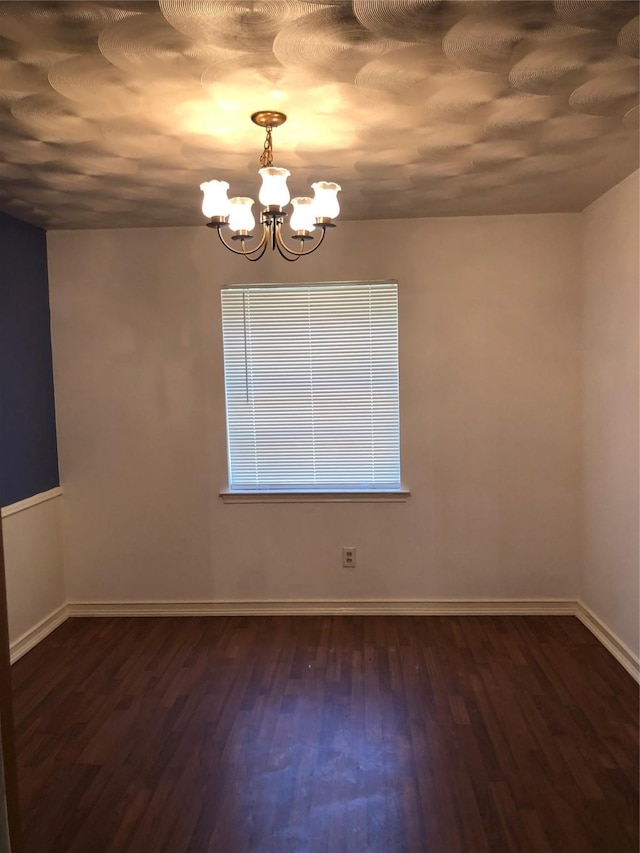 608 Spinner Rd, Desoto, TX 75115 - unfurnished room with a chandelier, dark wood-style floors, and baseboards