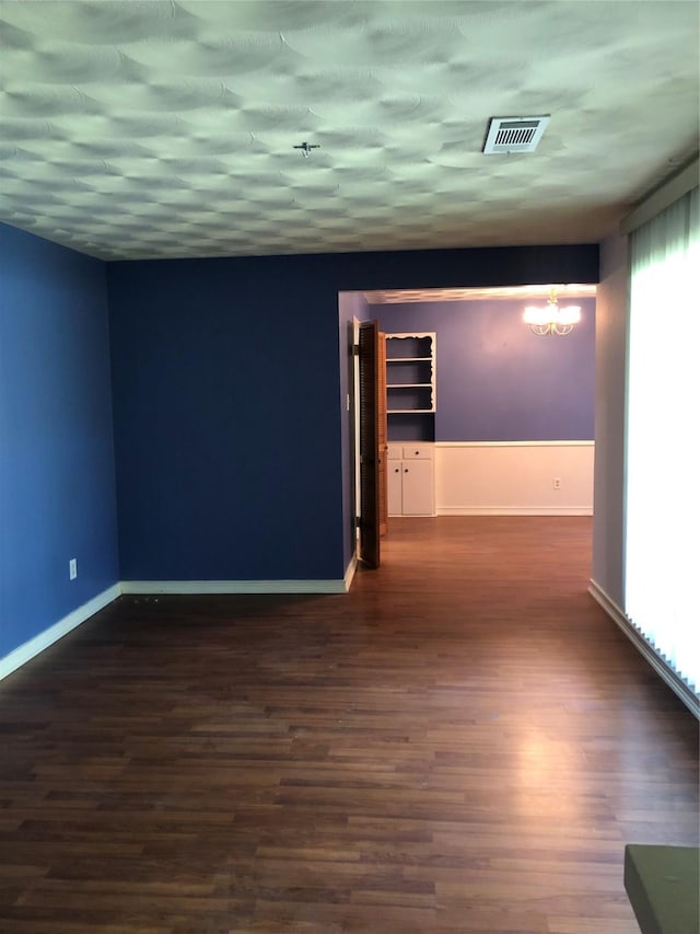 608 Spinner Rd, Desoto, TX 75115 - empty room featuring wood finished floors, baseboards, and a chandelier