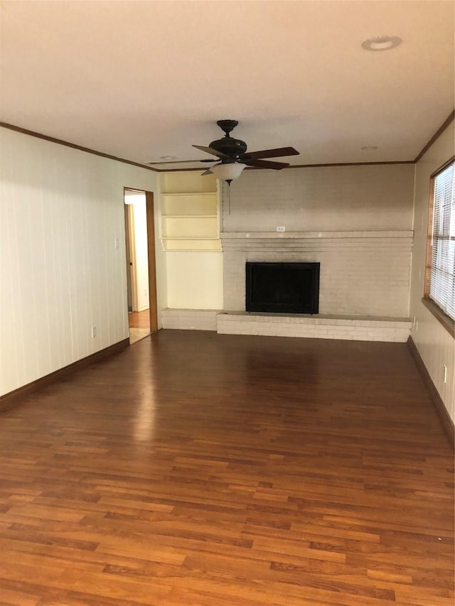 608 Spinner Rd, Desoto, TX 75115 - unfurnished living room with a ceiling fan, wood finished floors, a brick fireplace, baseboards, and ornamental molding