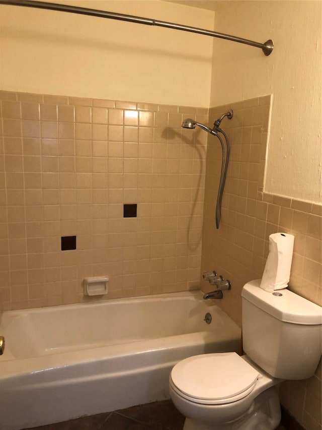 608 Spinner Rd, Desoto, TX 75115 - full bathroom with toilet, shower / bath combination, tile walls, and wainscoting