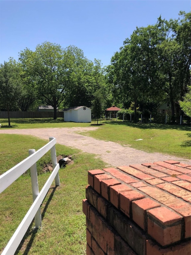 608 Spinner Rd, Desoto, TX 75115 - view of yard with a storage shed, an outdoor structure, and dirt driveway