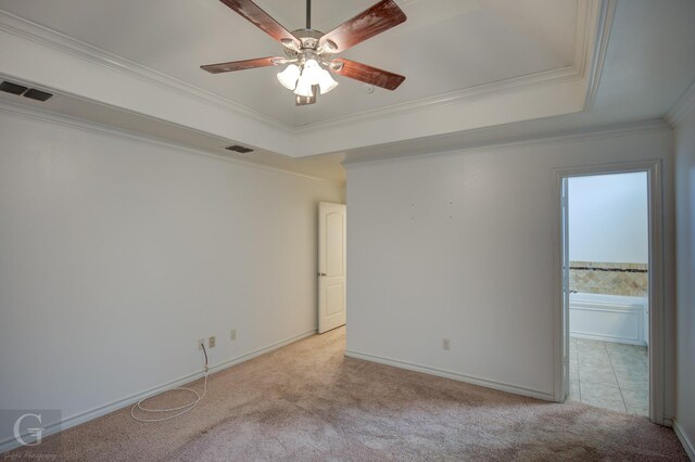 122 Lola Cir, Benton, LA 71006 - empty room with light colored carpet, a tray ceiling, ornamental molding, a ceiling fan, and baseboards