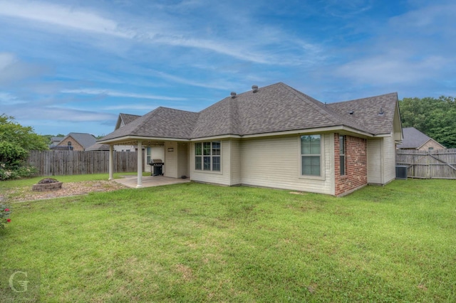 122 Lola Cir, Benton, LA 71006 - rear view of house featuring roof with shingles, a patio, a fire pit, central AC unit, and brick siding