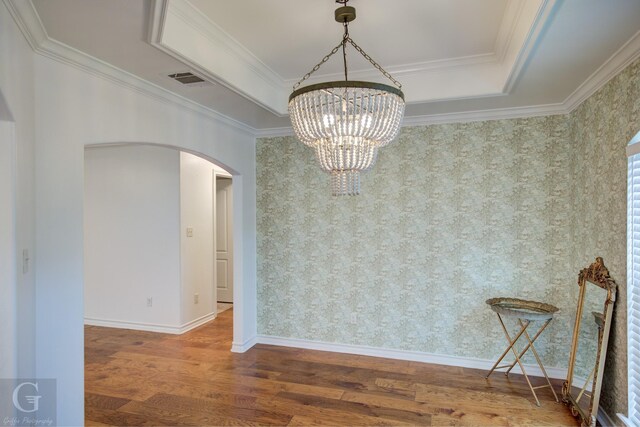 122 Lola Cir, Benton, LA 71006 - unfurnished dining area with arched walkways, a chandelier, wood finished floors, ornamental molding, and wallpapered walls