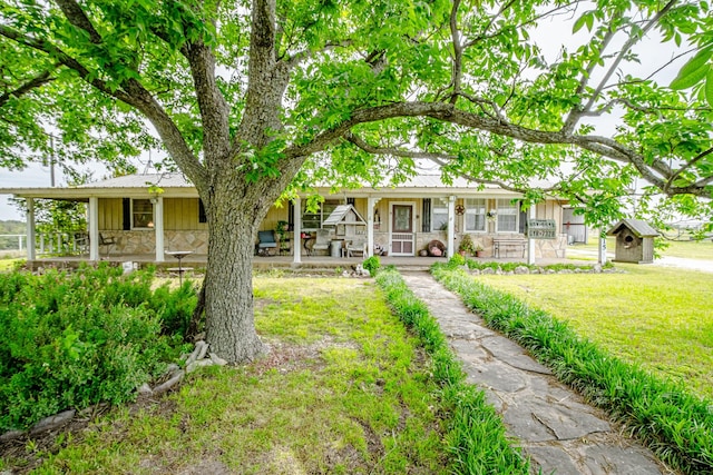 12815 N Fm 219, Dublin, TX 76446 - view of front facade with covered porch, stone siding, board and batten siding, and a front lawn