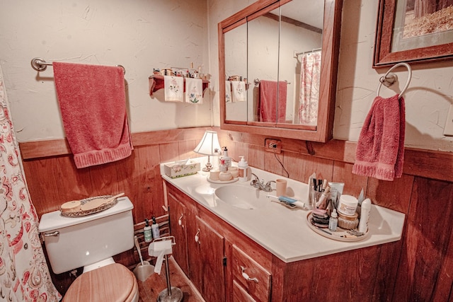 12815 N Fm 219, Dublin, TX 76446 - full bath with a wainscoted wall, toilet, vanity, and wooden walls