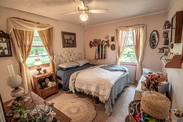 12815 N Fm 219, Dublin, TX 76446 - carpeted bedroom featuring crown molding, a textured ceiling, and ceiling fan
