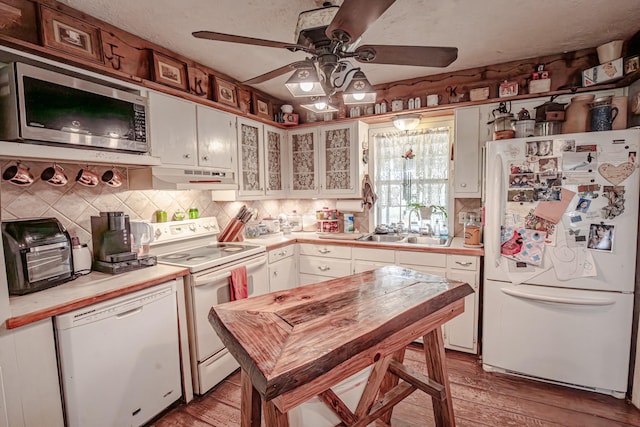 12815 N Fm 219, Dublin, TX 76446 - kitchen featuring white appliances, under cabinet range hood, ceiling fan, light wood finished floors, and white cabinetry