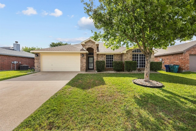 ranch-style home with central air condition unit, an attached garage, a front yard, concrete driveway, and a shingled roof