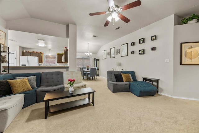 living room featuring lofted ceiling, light colored carpet, a chandelier, ceiling fan, and baseboards