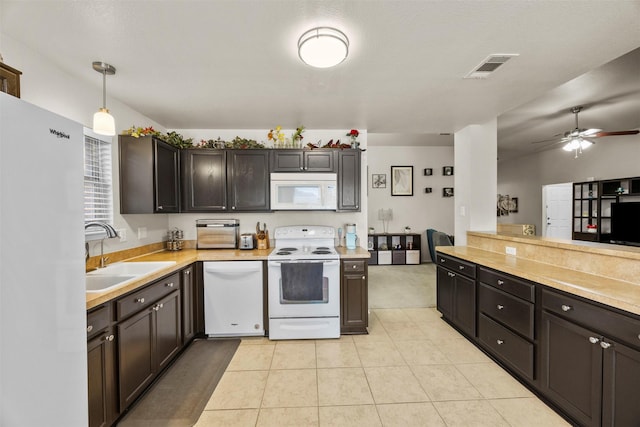 kitchen featuring white appliances, a sink, light countertops, a ceiling fan, and light tile patterned floors