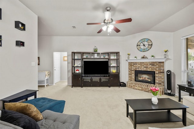 living area with a ceiling fan, light colored carpet, a fireplace, and baseboards