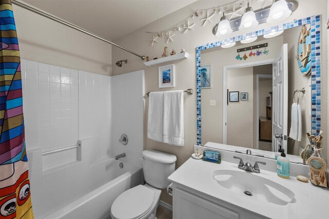 bathroom with toilet, vanity, and shower / tub combo