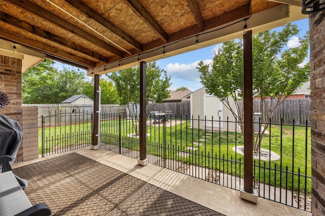view of patio featuring a shed and an outdoor structure