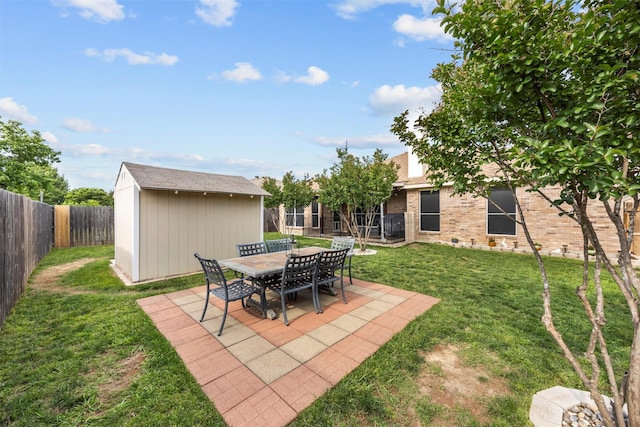 view of yard with a storage shed, a patio, and an outdoor structure