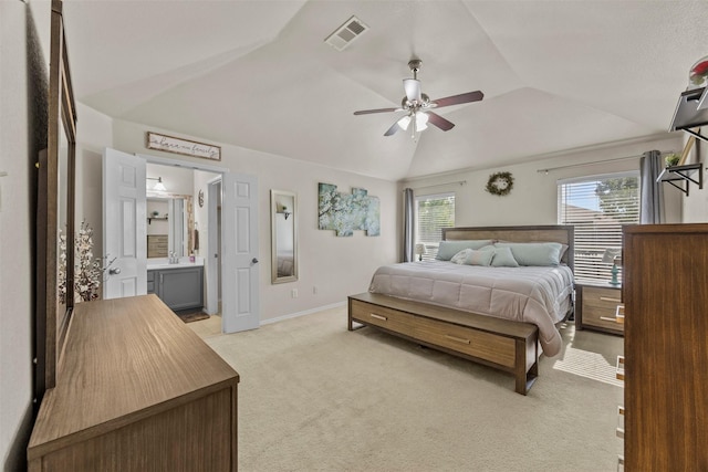 bedroom featuring lofted ceiling, light colored carpet, baseboards, connected bathroom, and ceiling fan